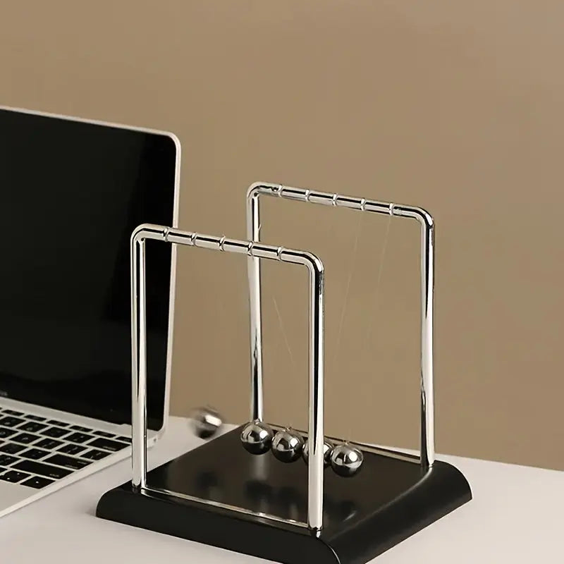 Newton's Cradle, made of durable PP material, is both a desktop physics demonstration pendulum and a stress-relieving decorative piece for offices and homes, ideal as a creative gift. Wholesale Hub